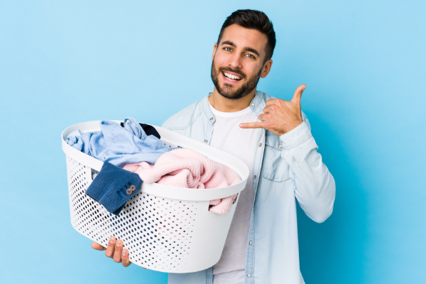 Man With Laundry Gesturing A Phone Call 600X400